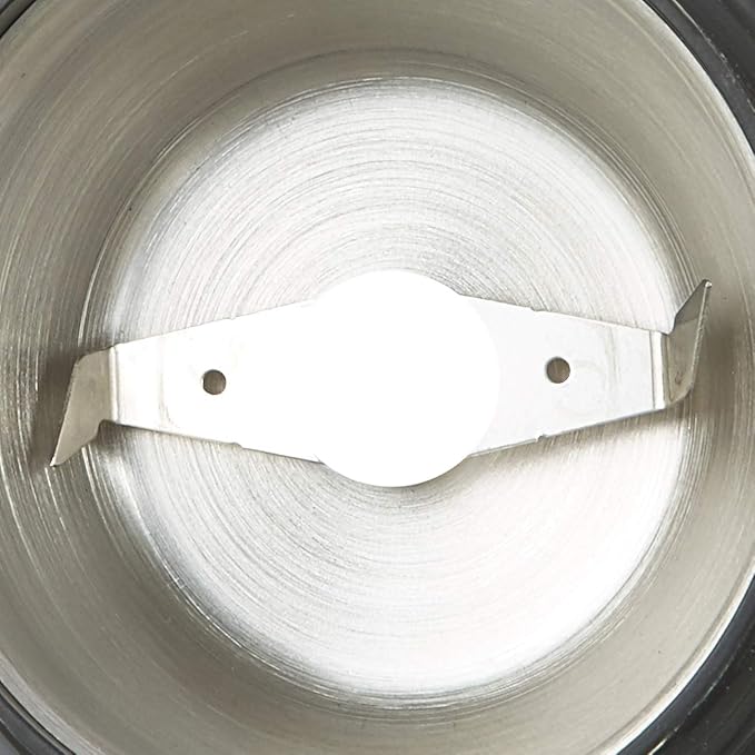 Close-up of the silver Capresso grinder's push-button control, highlighting ease of use.